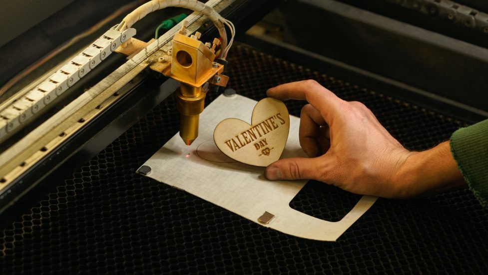 laser cutting beam over plywood sheet